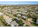 Aerial view showcasing a neighborhood with lush landscaping, solar panels, and a nearby waterfront at 4127 53Rd S Ave, St Petersburg, FL 33711