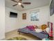 This bedroom features a ceiling fan and a window, creating an inviting and cheerful atmosphere at 4127 53Rd S Ave, St Petersburg, FL 33711