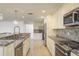 Well-lit kitchen boasting stainless steel appliances and attractive granite countertops at 4127 53Rd S Ave, St Petersburg, FL 33711