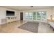 Spacious living room featuring large windows, tile flooring, and plenty of natural light at 4127 53Rd S Ave, St Petersburg, FL 33711
