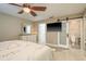 Bright main bedroom features an ensuite bathroom, ceiling fan, tiled floors, and built in television at 4127 53Rd S Ave, St Petersburg, FL 33711