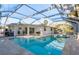 Inviting pool area with a screened enclosure and tiled patio, ideal for relaxation and recreation at 4127 53Rd S Ave, St Petersburg, FL 33711