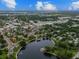 Aerial view of a charming town featuring a scenic lake, lush trees and quaint homes at 441 Village Dr, Tarpon Springs, FL 34689