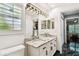 Bathroom with a window and double sink vanity at 441 Village Dr, Tarpon Springs, FL 34689