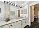 Bright bathroom vanity with marble countertops, double sinks, and modern lighting fixtures at 441 Village Dr, Tarpon Springs, FL 34689