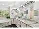 Bright bathroom with double vanities, granite countertops, tub, and black marble flooring with an artistic aesthetic at 441 Village Dr, Tarpon Springs, FL 34689