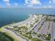 Scenic beach view showcasing white sand, palm trees, and ample parking at 441 Village Dr, Tarpon Springs, FL 34689