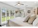 Bright bedroom with sliding glass doors to the outside and mirrored closet doors at 441 Village Dr, Tarpon Springs, FL 34689