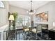 Bright dining room featuring a glass table, contemporary chandelier, and large windows with lots of light at 441 Village Dr, Tarpon Springs, FL 34689