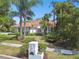 Beautiful home with a well-manicured lawn, mature landscaping, and a unique mailbox at 441 Village Dr, Tarpon Springs, FL 34689