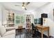 Bright home office area features custom built-in shelves, desk, and large window at 441 Village Dr, Tarpon Springs, FL 34689