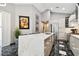 Modern kitchen features an island with marble countertop, stainless steel appliances, and black marble flooring at 441 Village Dr, Tarpon Springs, FL 34689