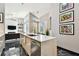 Bright kitchen boasts a spacious island, stainless steel appliances, and black marble flooring at 441 Village Dr, Tarpon Springs, FL 34689