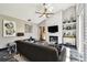 Cozy living room with high ceilings, sleek fireplace, and a comfortable seating area with natural light at 441 Village Dr, Tarpon Springs, FL 34689
