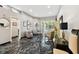 Modern living room with unique decor, striking marble floors, and lots of natural light at 441 Village Dr, Tarpon Springs, FL 34689