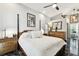 Comfortable bedroom features a four-poster bed, dresser, and black marble flooring with an artistic aesthetic at 441 Village Dr, Tarpon Springs, FL 34689