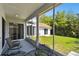 Relaxing patio with views of the lush backyard and a charming outdoor dining area at 441 Village Dr, Tarpon Springs, FL 34689