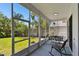 Enclosed patio with a clear view of the well-maintained backyard and tropical landscaping at 441 Village Dr, Tarpon Springs, FL 34689