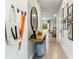 Bright hallway featuring tile floors, coat rack, and staircase, leading to an open living space at 4454 Rachel Falls Dr, Tampa, FL 33610