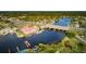 Picturesque aerial view of waterfront dining and docks along the river under a scenic bridge at 4844 Anchorage Cv, Port Richey, FL 34668