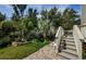 Backyard area featuring tropical foliage, a paver patio, and stairway at 4844 Anchorage Cv, Port Richey, FL 34668