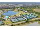 Scenic aerial view of the community, golf course, tennis courts, and surrounding lakes at 5020 Mill Pond Rd # 3158 & 3160, Wesley Chapel, FL 33543