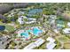 Stunning aerial view of the community pool, tennis courts, and lush landscaping at 5020 Mill Pond Rd # 3158 & 3160, Wesley Chapel, FL 33543