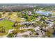 A high-angle view showing the condo's proximity to a golf course, ponds, parking and nearby trees at 5020 Mill Pond Rd # 3158 & 3160, Wesley Chapel, FL 33543
