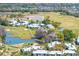 Aerial view of community nestled among golf courses, lakes, and mature trees at 5020 Mill Pond Rd # 3158 & 3160, Wesley Chapel, FL 33543