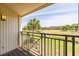 Balcony view of a golf course with palm trees and a water feature on a sunny day at 5020 Mill Pond Rd # 3158 & 3160, Wesley Chapel, FL 33543