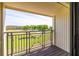 Balcony view of a green golf course with trees and a water feature on a sunny day at 5020 Mill Pond Rd # 3158 & 3160, Wesley Chapel, FL 33543
