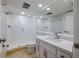 All-white bathroom features a glass shower and a modern vanity with stone countertops at 5020 Mill Pond Rd # 3158 & 3160, Wesley Chapel, FL 33543
