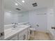 All-white bathroom with large mirror over vanity at 5020 Mill Pond Rd # 3158 & 3160, Wesley Chapel, FL 33543