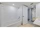 Bathroom featuring a white tile shower/tub and a door to an additional area at 5020 Mill Pond Rd # 3158 & 3160, Wesley Chapel, FL 33543