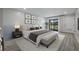Staged bedroom with gray walls, wood floors, and access to balcony at 5020 Mill Pond Rd # 3158 & 3160, Wesley Chapel, FL 33543