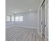 Empty bedroom with natural light, wood floors, and french doors to another room at 5020 Mill Pond Rd # 3158 & 3160, Wesley Chapel, FL 33543