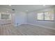 Bright room with wood floors and access to a bathroom with dual vanities at 5020 Mill Pond Rd # 3158 & 3160, Wesley Chapel, FL 33543
