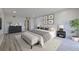 Staged bedroom with gray walls, wood floors, and a neutral color scheme at 5020 Mill Pond Rd # 3158 & 3160, Wesley Chapel, FL 33543
