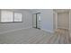 Cozy bedroom with light gray walls, wood floors, and a large mirrored closet at 5020 Mill Pond Rd # 3158 & 3160, Wesley Chapel, FL 33543