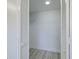 Bright walk-in closet with white wood floors and white shelving at 5020 Mill Pond Rd # 3158 & 3160, Wesley Chapel, FL 33543