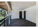 View of a condo's entrance featuring a balcony, two doors with number and tropical nature landscape around it at 5020 Mill Pond Rd # 3158 & 3160, Wesley Chapel, FL 33543