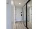 Hallway with access to bathroom and closet with mirror doors at 5020 Mill Pond Rd # 3158 & 3160, Wesley Chapel, FL 33543