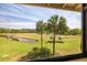 Scenic golf course view with palm trees and a water hazard at 5020 Mill Pond Rd # 3158 & 3160, Wesley Chapel, FL 33543
