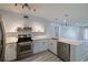 Modern kitchen featuring stainless steel appliances, stylish cabinetry and countertops, and sleek hardwood floors at 5020 Mill Pond Rd # 3158 & 3160, Wesley Chapel, FL 33543