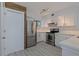 Updated kitchen featuring stainless steel appliances, white cabinets, and marble countertops at 5020 Mill Pond Rd # 3158 & 3160, Wesley Chapel, FL 33543