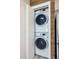 Convenient laundry closet featuring a stacked washer and dryer unit, perfect for space-saving in this home at 5020 Mill Pond Rd # 3158 & 3160, Wesley Chapel, FL 33543