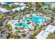 Birds-eye view of a stunning swimming pool featuring winding water, poolside furniture, and palm trees at 5020 Mill Pond Rd # 3158 & 3160, Wesley Chapel, FL 33543