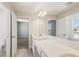 Bright bathroom featuring dual sinks, quartz countertops, and modern fixtures at 5335 Wolf Creek Dr, Apollo Beach, FL 33572
