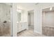 Elegant bathroom boasts a glass shower, vanity, modern fixtures, and an adjacent walk-in closet at 5335 Wolf Creek Dr, Apollo Beach, FL 33572