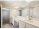 Bright bathroom featuring dual sinks, quartz countertops, and modern fixtures at 5335 Wolf Creek Dr, Apollo Beach, FL 33572